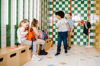 2 Boys and Girl Standing on White Floor Tiles