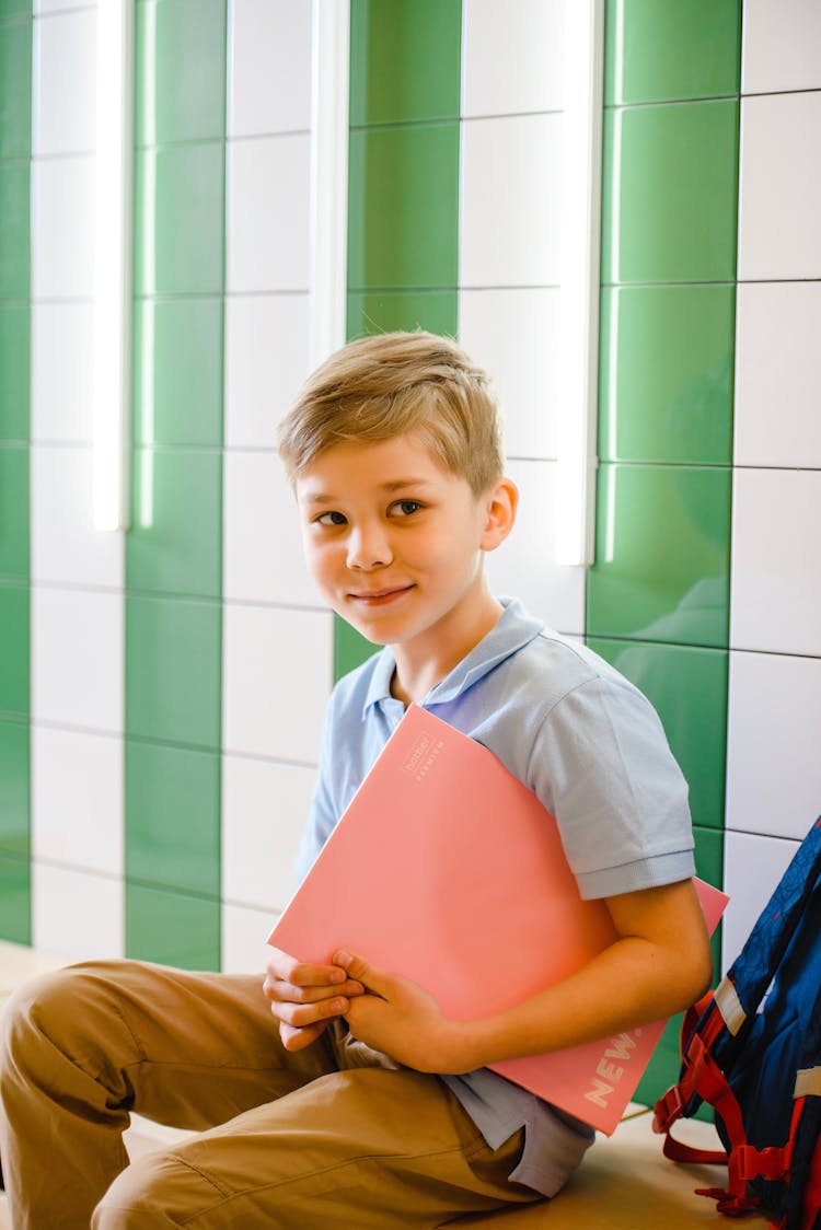 Blond Boy Holding A Book