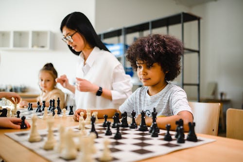 A Boy and a Girl Playing Chess