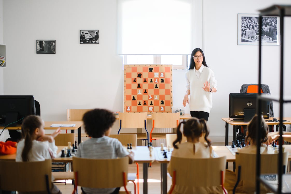 Free A Woman Standing In Front of Young Children Stock Photo