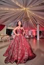 Woman in Red Floral Dress Standing on White Floor