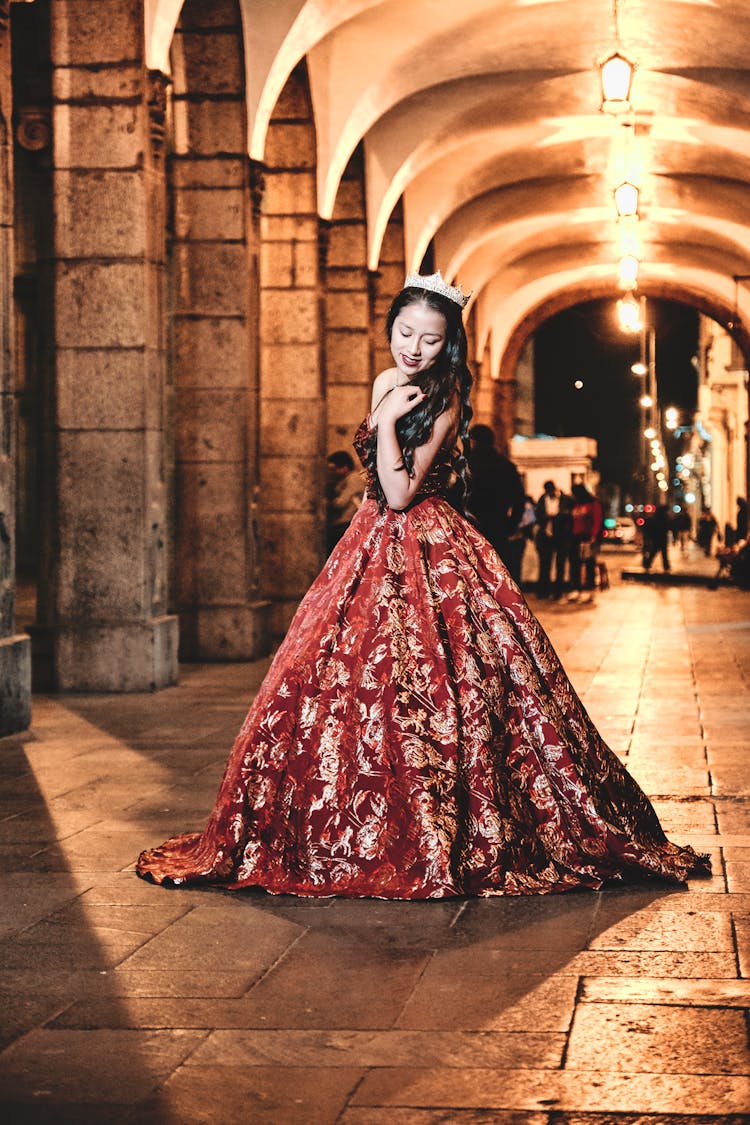 Woman In Gown Near Arch At Night