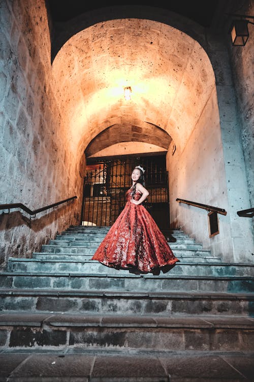 Woman in Red Dress Posing on Stairway
