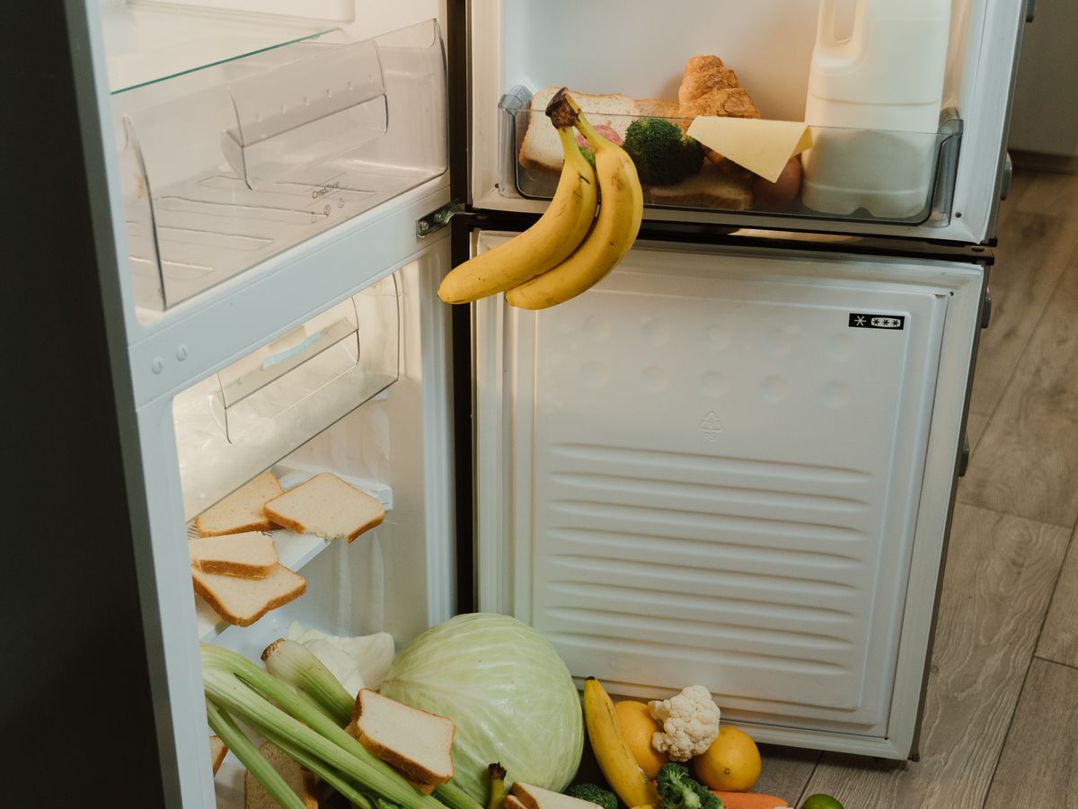Open refrigerator packed with food, illustrating the mistake of overbuying for one-person meal prep