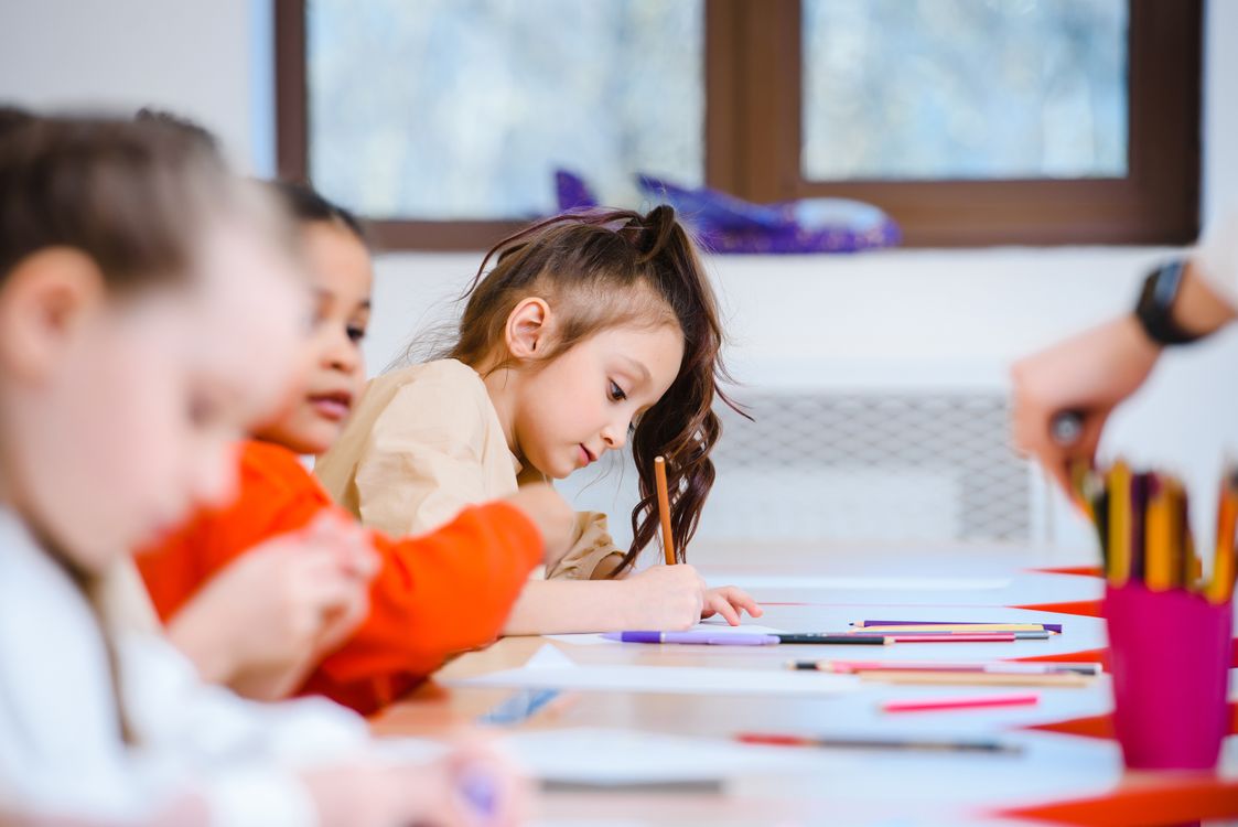 Young girl focused on a colouring activity