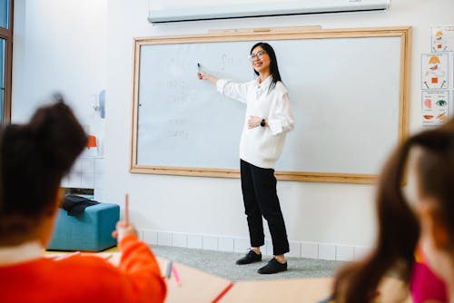 Free A Woman Teaching in Front of the Class Stock Photo