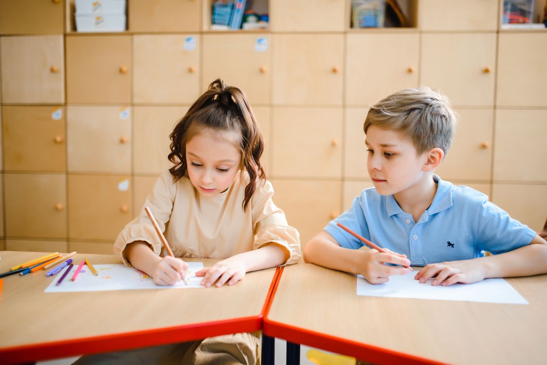 Children drawing with colored pencils as part of a balanced, hands-on learning activity
