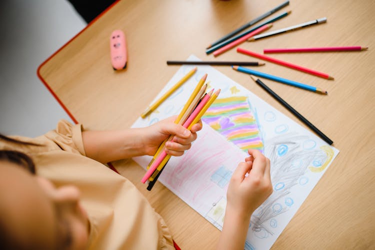 A Child Drawing On A Paper