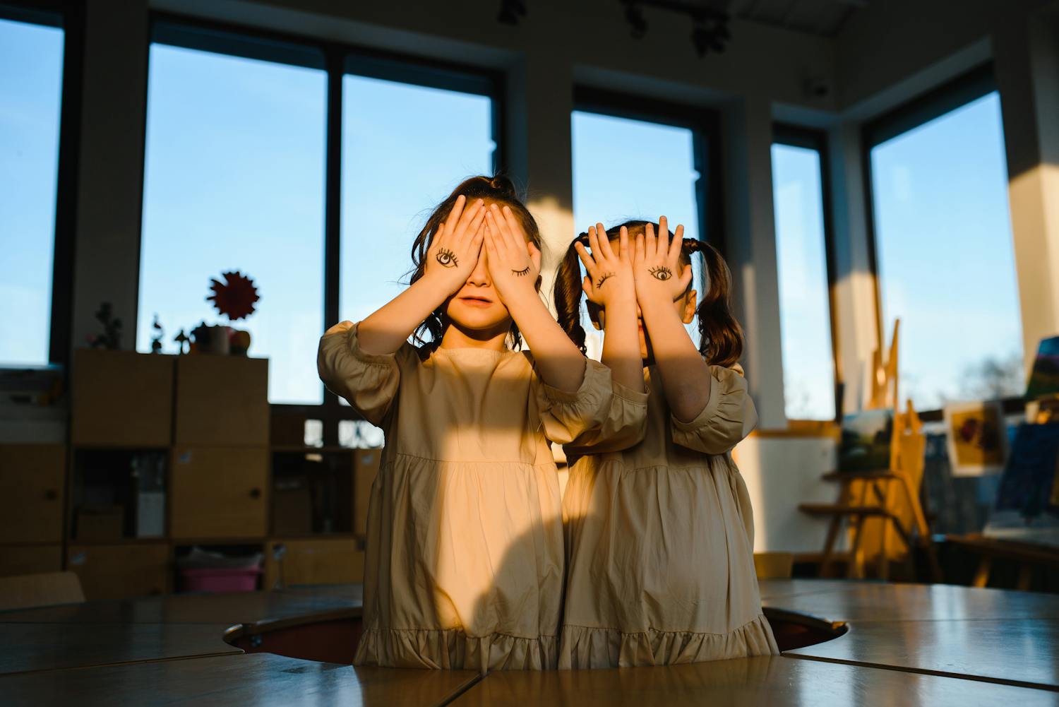 Two young girls play indoors
