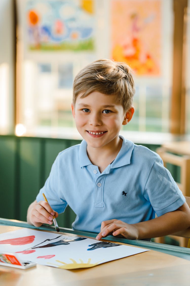 A Boy In Blue Polo Smiling