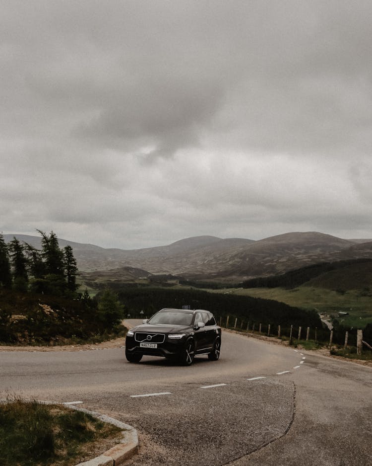 Black Suv Driving On An Uphill Road