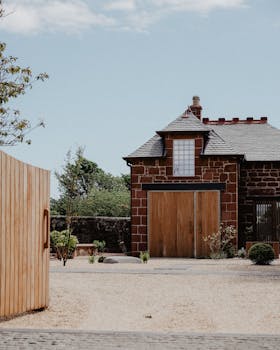 Charming brick house with wooden doors set in the tranquil Scottish countryside.