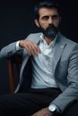 Man in Gray Suit Jacket Sitting on Black Chair