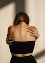 Back View of a Woman Reaching her Back