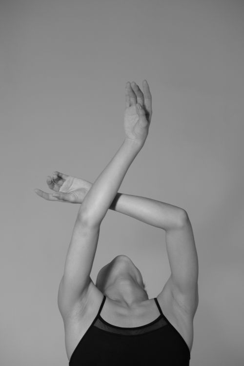 Free A graceful dancer in a monochrome image with arms elegantly crossed above the head. Stock Photo