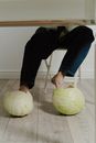 Person in Blue Denim Jeans and Brown Leather Boots Holding Yellow Ball