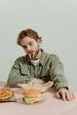 Man in Gray Zip Up Jacket Eating Food