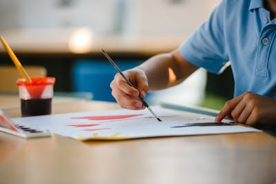 Child painting with watercolors