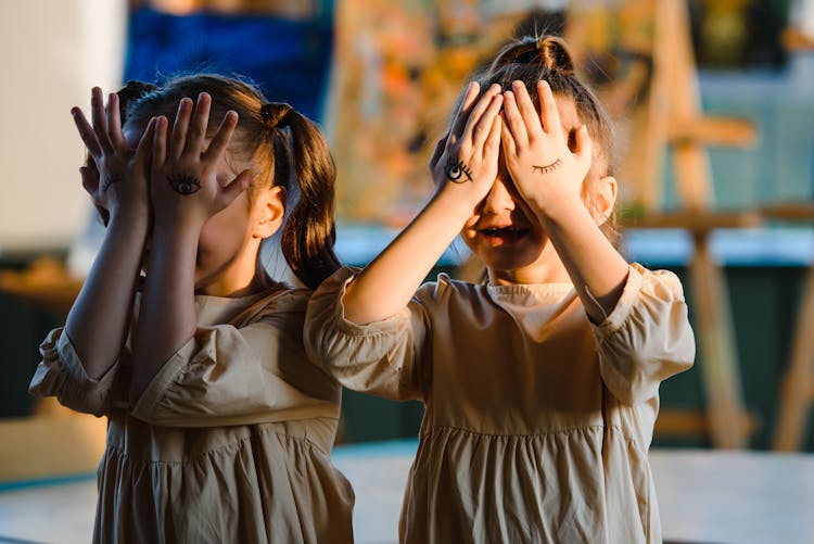 Two Girls Playing Face Palm