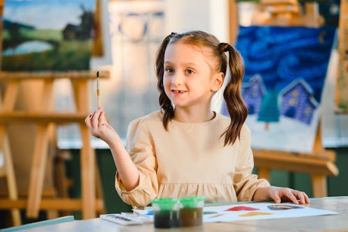 Cute Girl holding a Paint Brush 