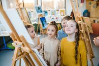 Children standing near an Easel