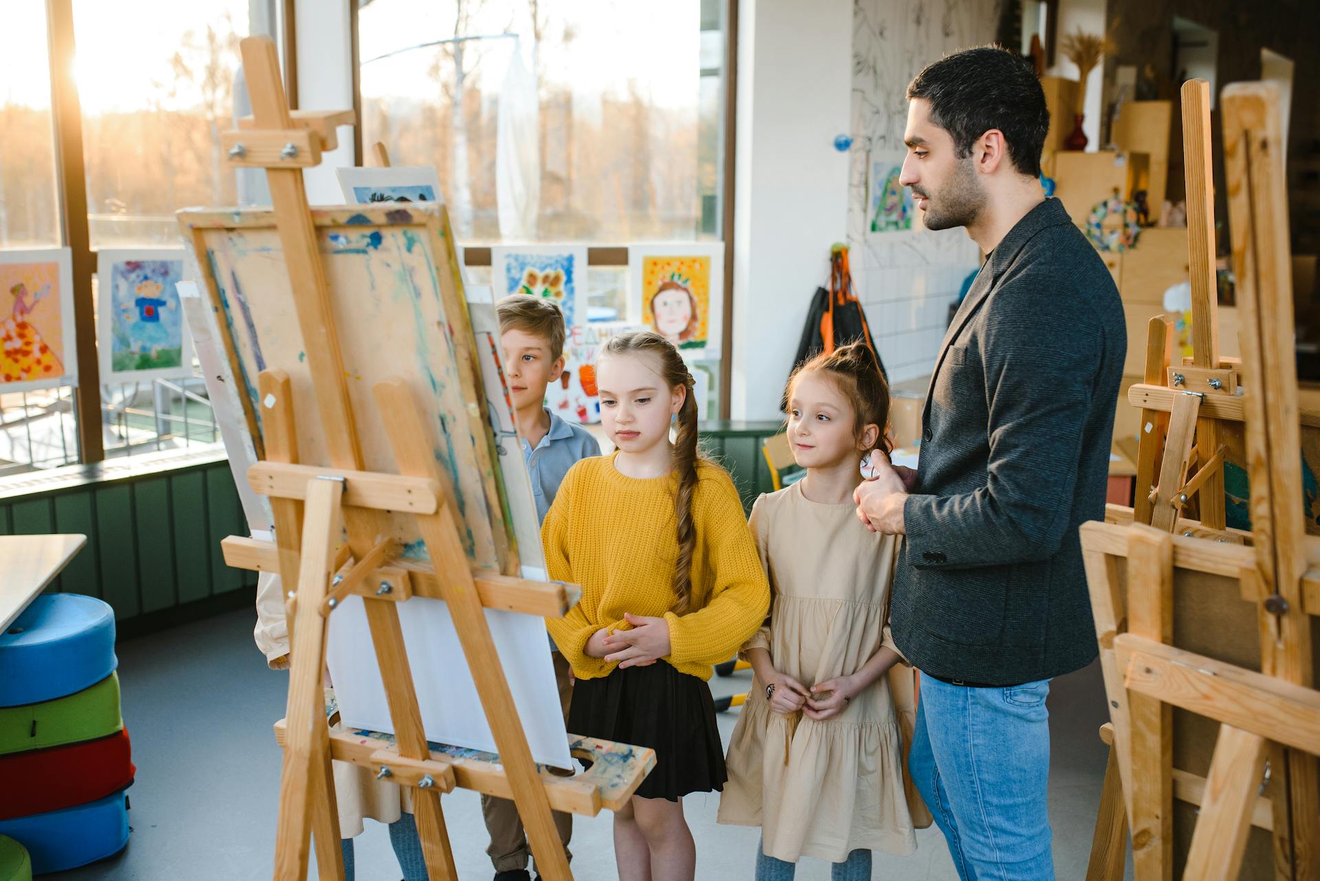 Children standing near an Easel 