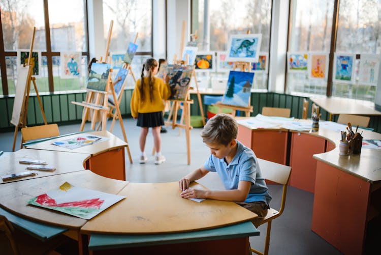 A Boy And A Girl Inside A Classroom 