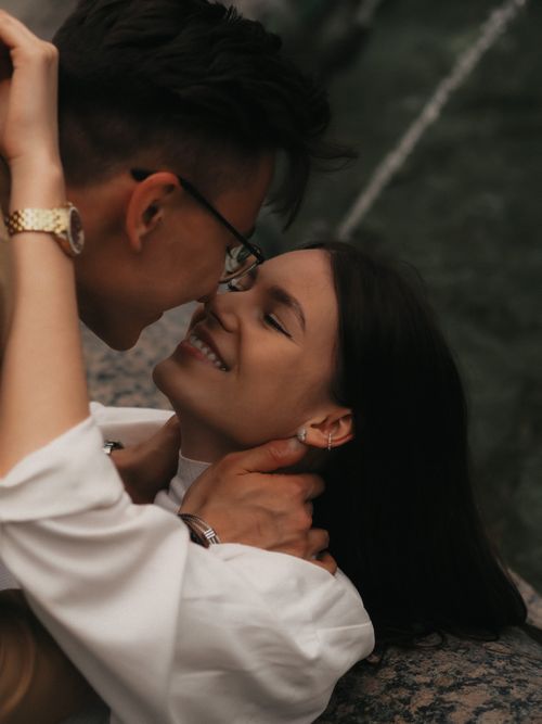 Free Loving couple sharing a tender moment outdoors against a natural backdrop in Moscow. Stock Photo