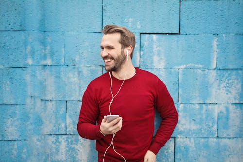 Free Photo of a Man Listening Music on his Phone Stock Photo