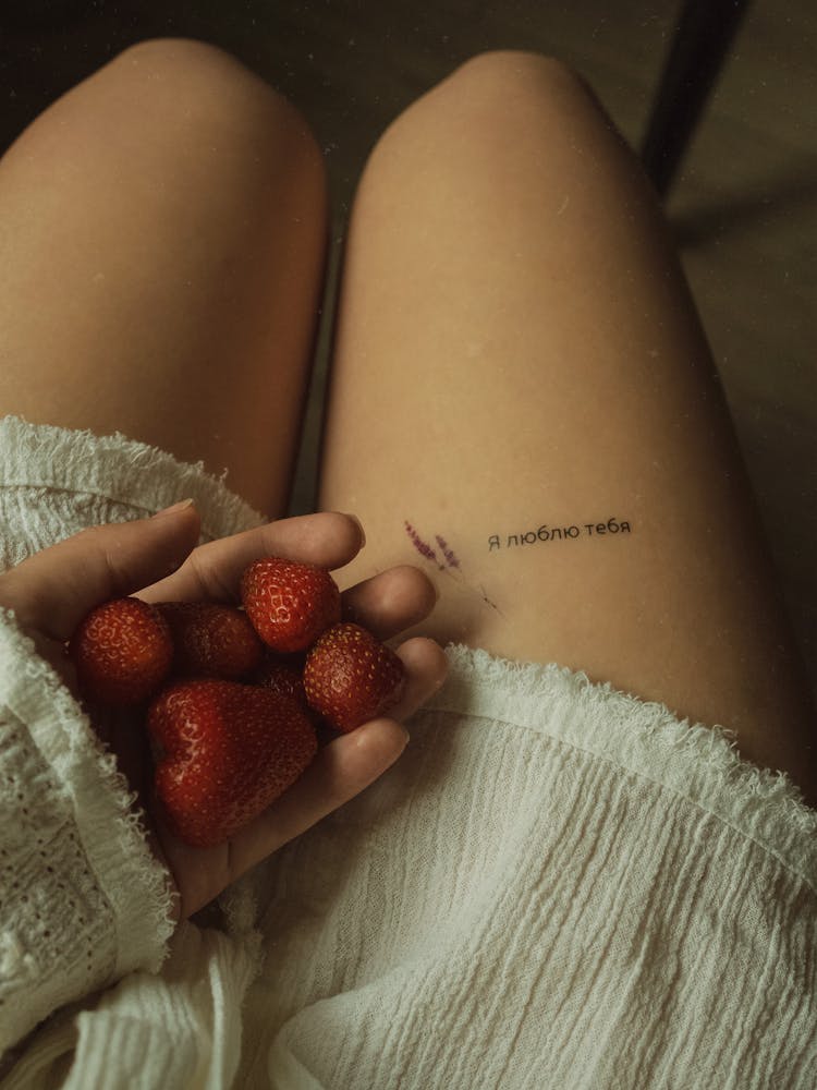 Person Holding Strawberries On Lap