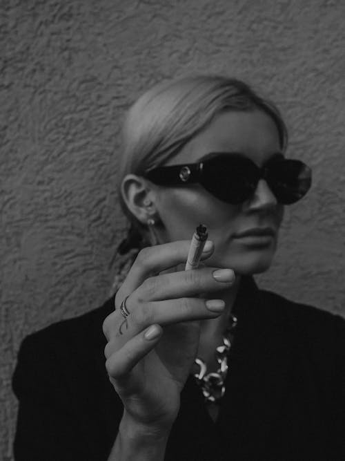 Grayscale Photo of Woman Holding a Cigarette 
