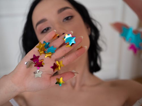 Free Shimmering Star Crafts on a Woman's Hand Stock Photo