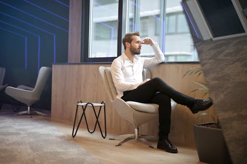 Free Photo of a Man Sitting Near the Windoww Stock Photo