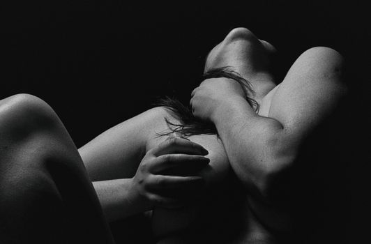Expressive monochrome nude portrait emphasizing body and emotion.