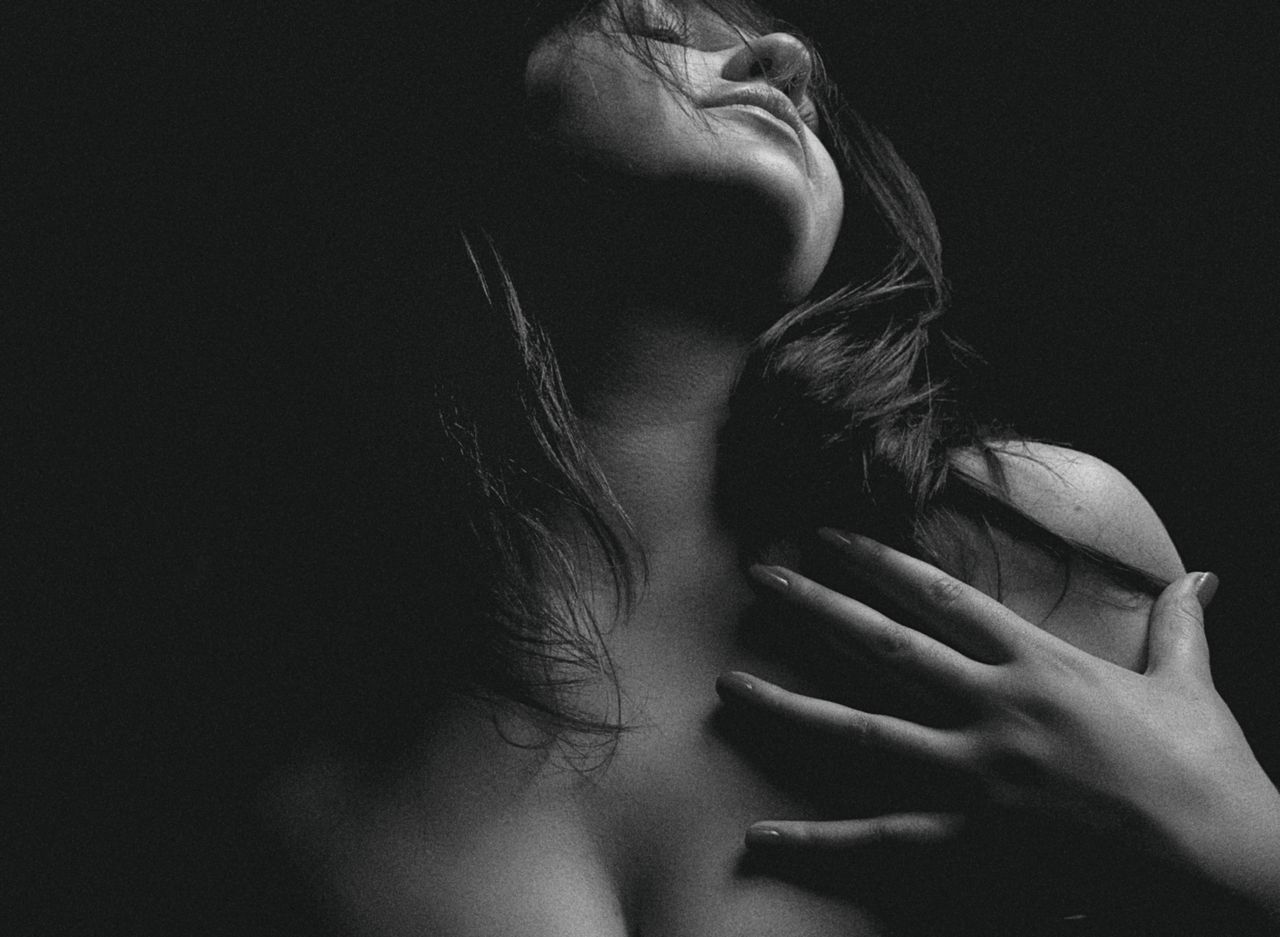 a captivating and sensual black and white portrait of a woman in a moo