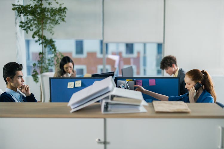 Four People Working In The Office