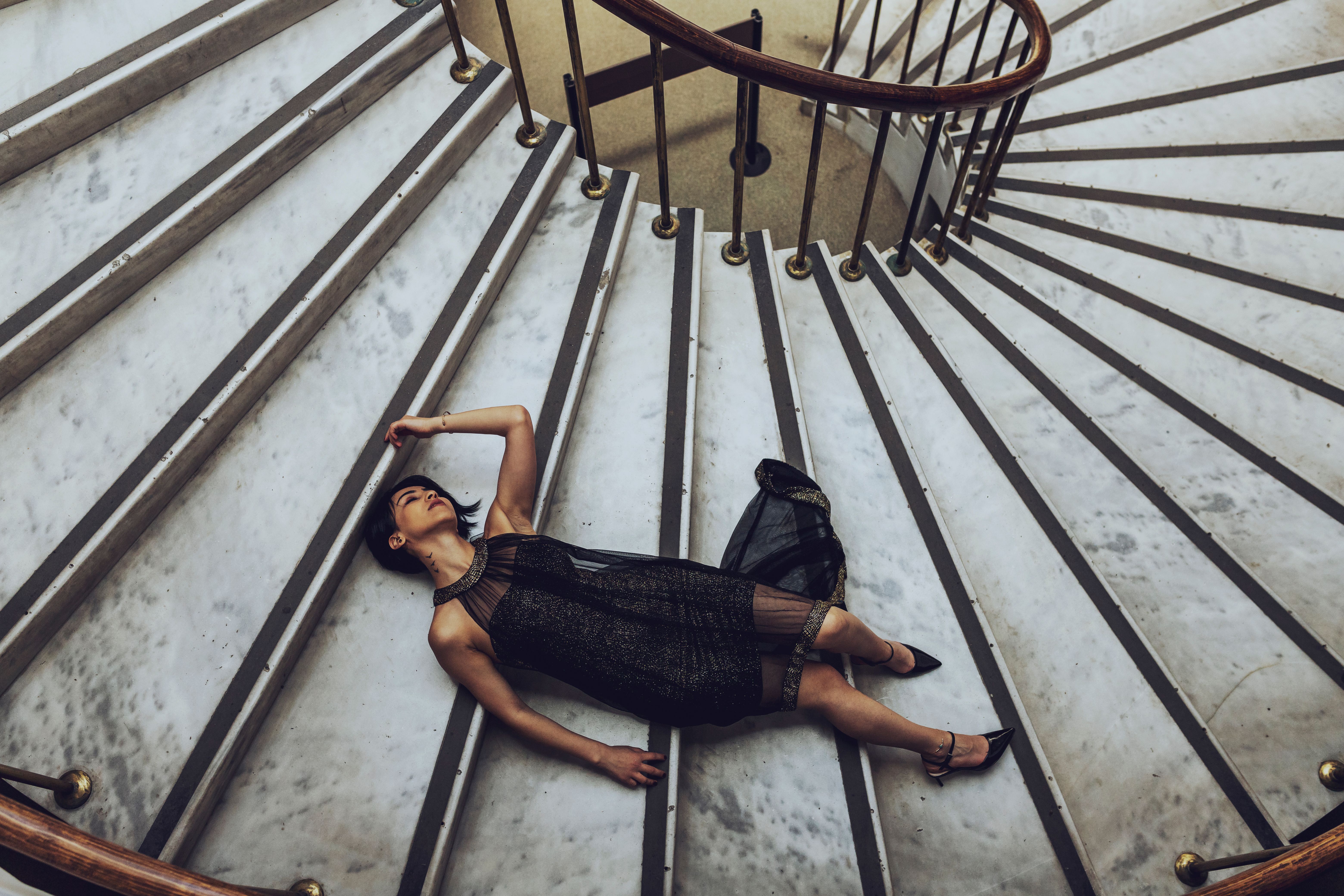 Woman in Black Dress Lying on Stairs · Free Stock Photo