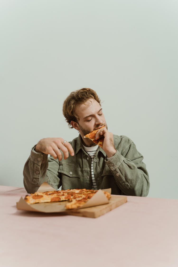 A Man Eating Pizza