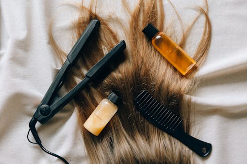 Free Black Hair Comb Beside White Plastic Bottle Stock Photo