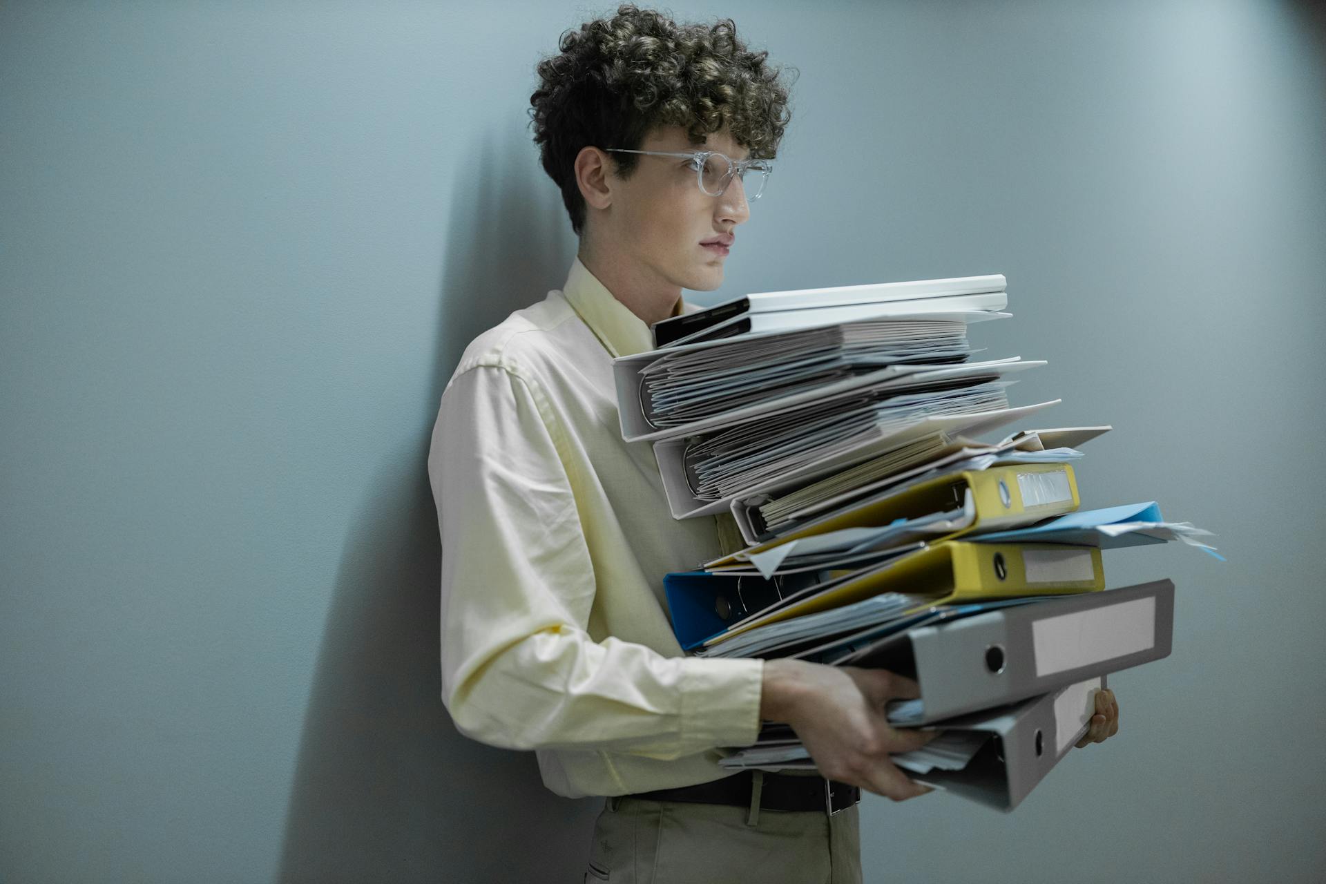 Man Holding Pile of Documents