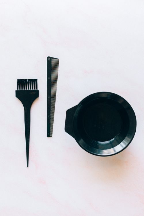 Free Set of hairdressing tools for color application, including brush, comb, and bowl. Stock Photo