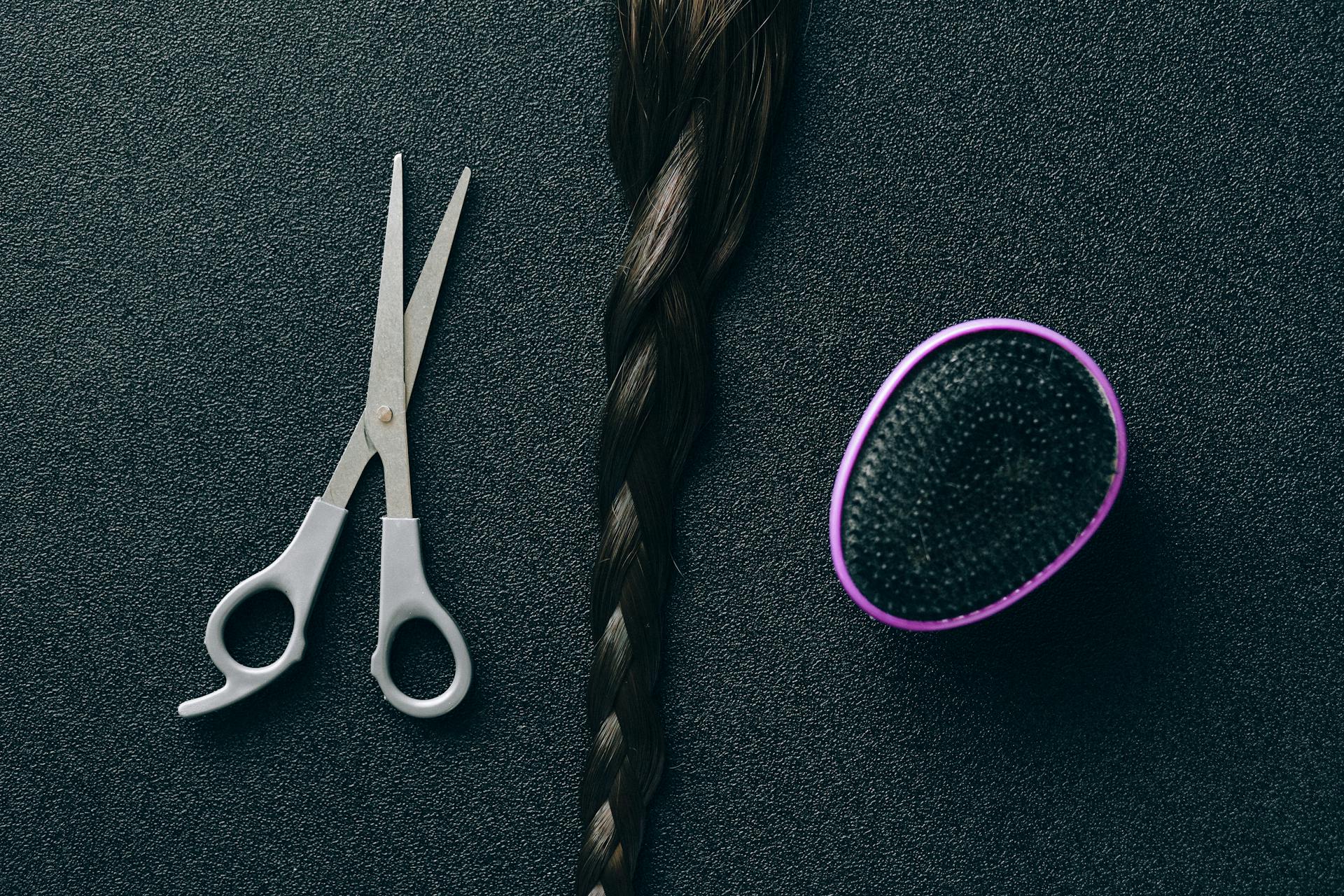 Silver Scissors Beside Black and Purple Hair Brush