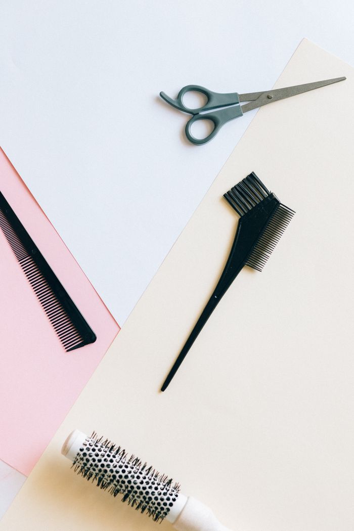 Professional wig styling tools laid out on a table