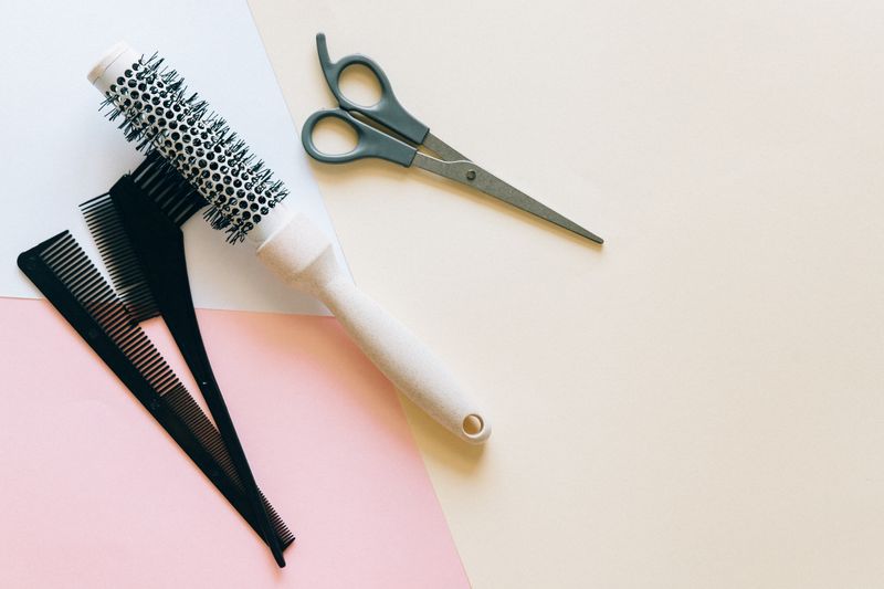 Wig brushes, combs and scissors flat lay