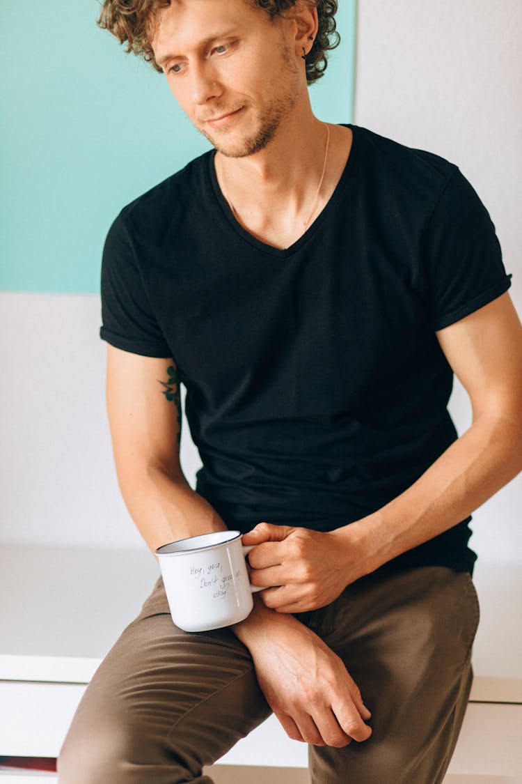 Man In Black T Shirt Holding A Mug