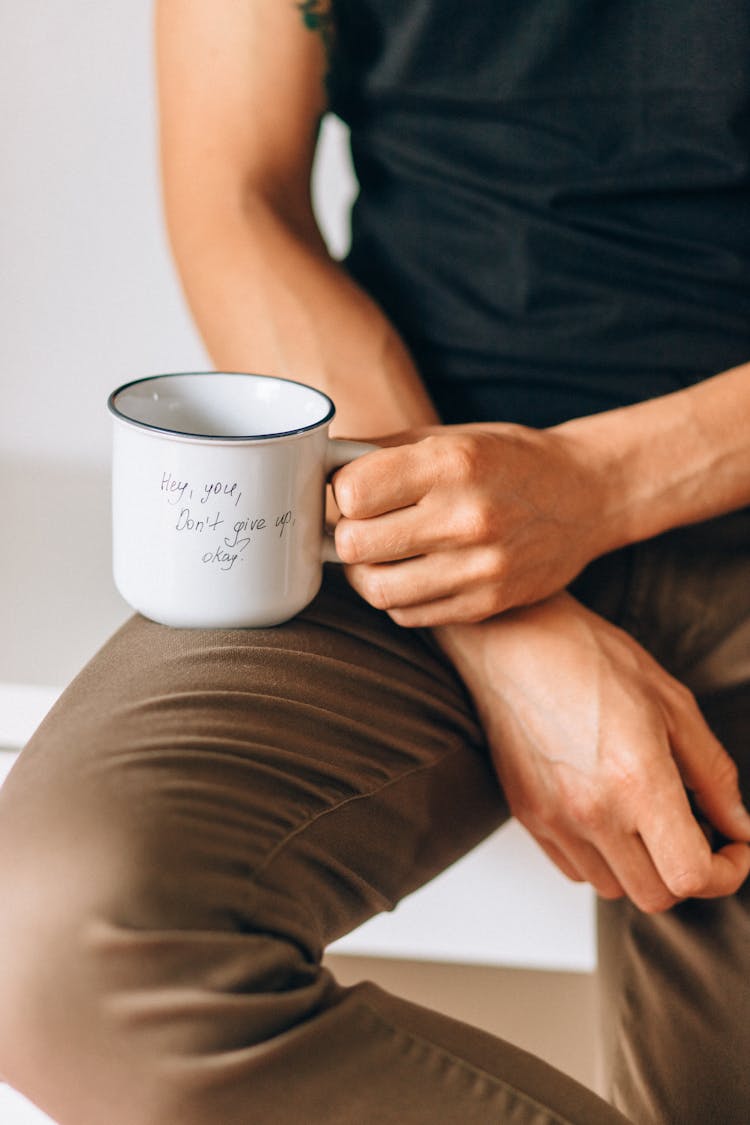 Person Holding White Mug With A Letter