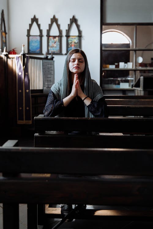 A Woman Praying while Her Eyes are Closed