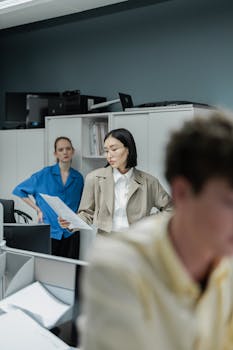A diverse team working together in a contemporary office space, reviewing documents.