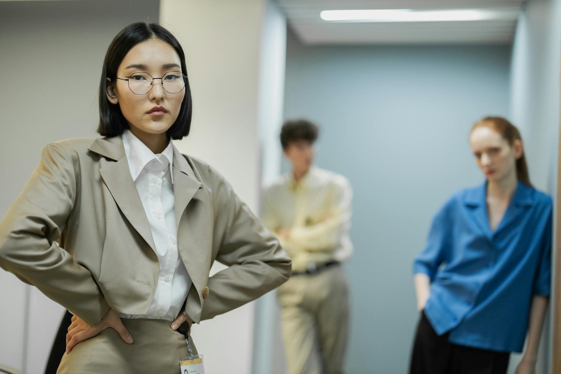 Diverse professionals in modern office attire, standing strategically for teamwork and collaboration.