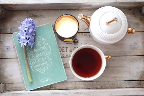 Free Teapot, a Mug of Tea, a Cup of Coffee and a Flower on a Wooden Tray Stock Photo